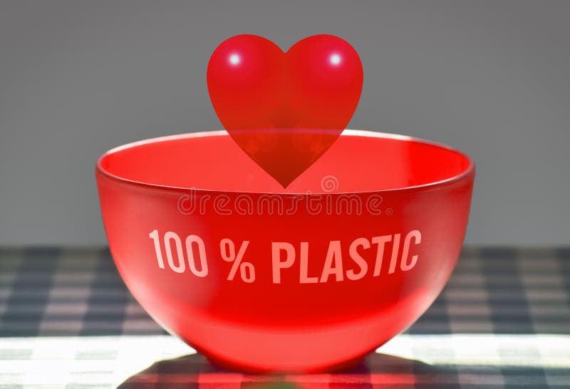 Plastic heart in a plastic bowl symbolizing fake love. Plastic heart in a plastic bowl symbolizing fake love