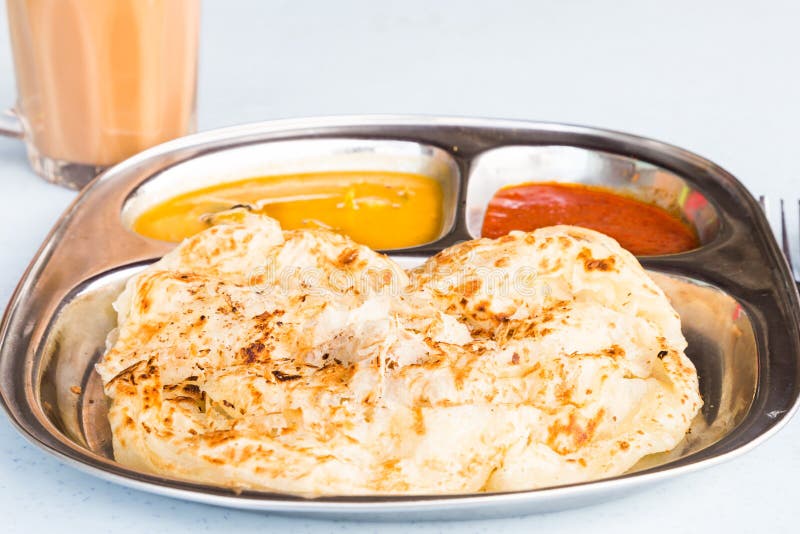 Roti Prata Or Roti Canai, A Traditional Indian Bread Served With Curry
