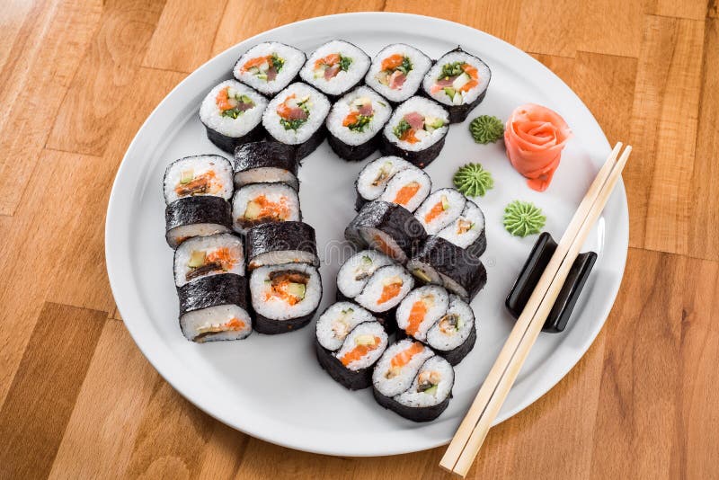 Rotoli di sushi di Maki con il salmone e l'avocado Sushi isolati a fondo bianco Fine in su fotografie stock Rotoli di sushi di Maki con il salmone e l'avocado Sushi isolati a fondo bianco Fine in su fotografie stock
