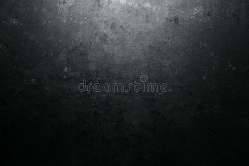Rough, dark stone background lit by spotlight stock image