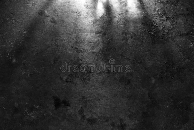 Rough, dark stone wall lit above by spotlight. Grunge background royalty free stock images