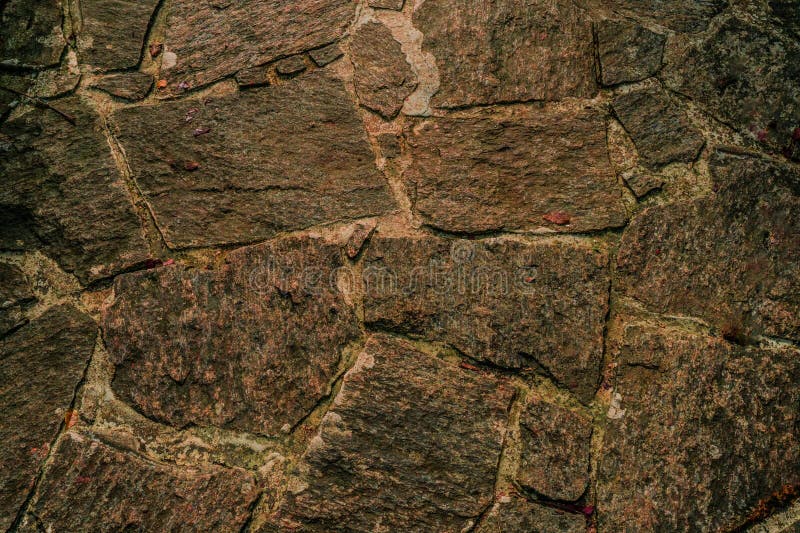 Rough stone wall with varying gray hues and natural textures. Irregular shapes form an interlocking pattern, creating a rustic and organic appearance. The surface features visible grains, cracks, and crevices, enhancing its tactile feel. Ideal for backgrounds, the wall offers an architectural charm and a sense of durability. Seamless brick textures stock images, royalty-free photos and pictures