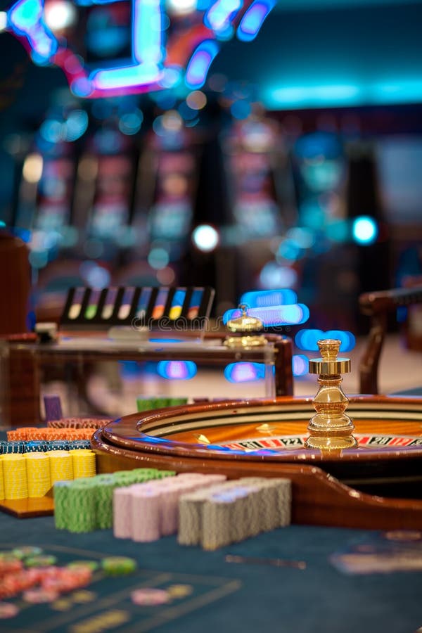 Roulette wheel table with chips piles stock image
