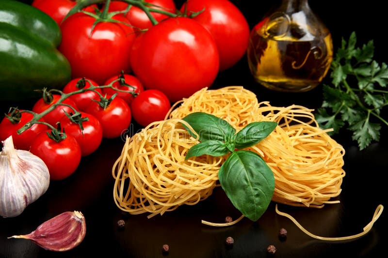 Round Balls of Pasta with Tomatoes,basil,olive Oil on Black Stock Image