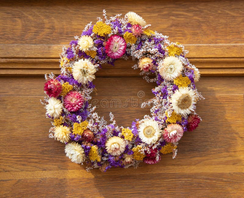 A round bouquet of colorful, vibrant dried flowers on an old wooden door. Autumn decoration stock photography A round bouquet of colorful, vibrant dried flowers on an old wooden door. Autumn decoration stock photography