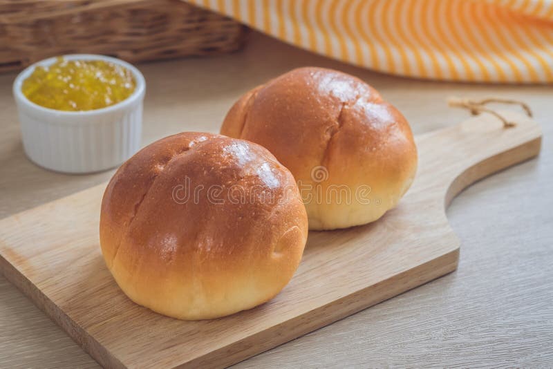 Round Bun, Bread Rolls on White Plate and Pineapple Jam Stock Photo