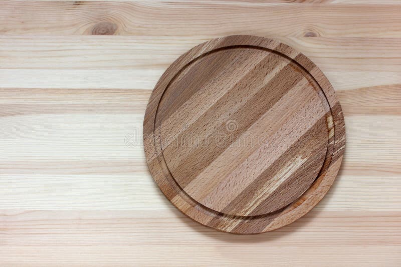 Round Cutting Board on the Table, Top View. Kitchen Worktop Stock Photo