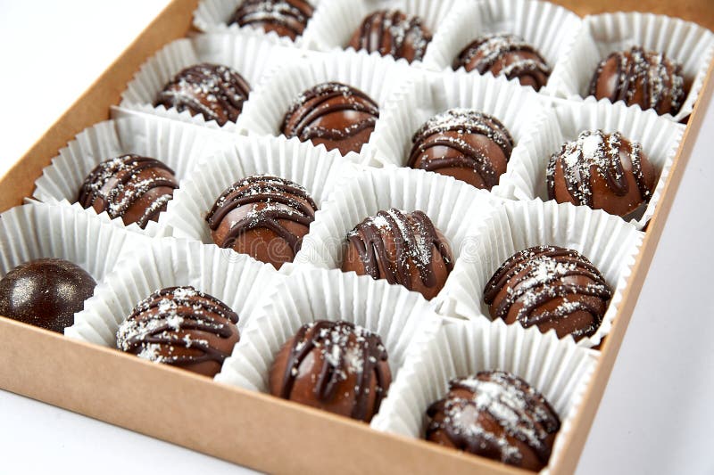 Round Dark Chocolate Candies in a White Box Close Up Stock Image