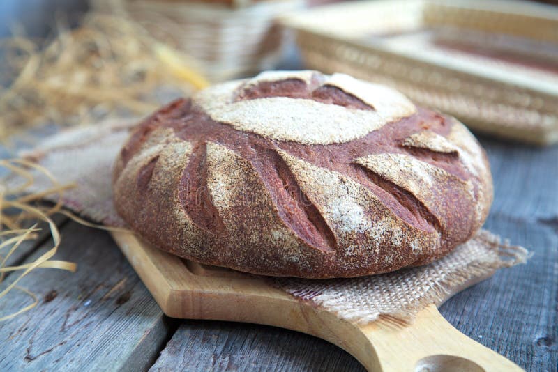 Round Loaf of Home made Bread made from rye, whole wheat flour and sourdough in rustic style, selective focus