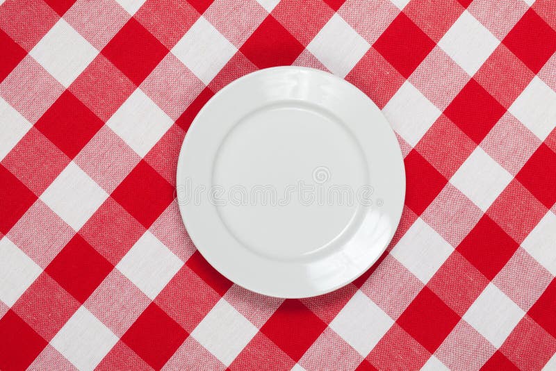 Round plate on red checked tablecloth stock photos