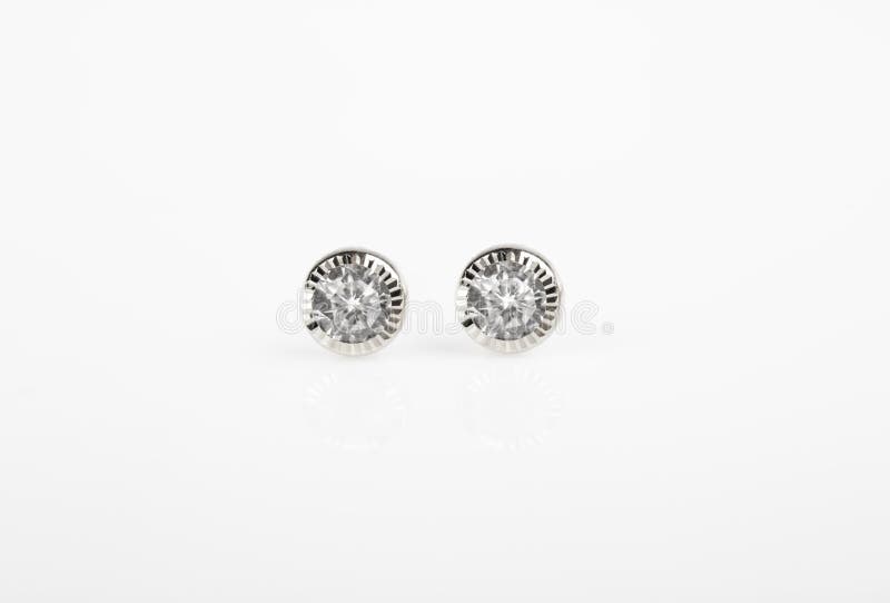 Round silver stud earrings with diamond on white background