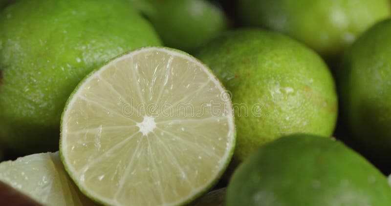 A round slice of a juicy lime slowly rotating. stock video footage