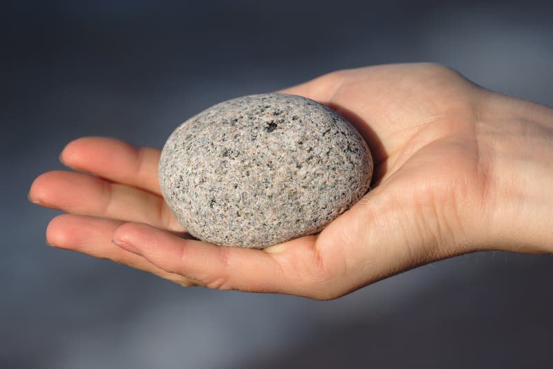 Round stone in hand. 