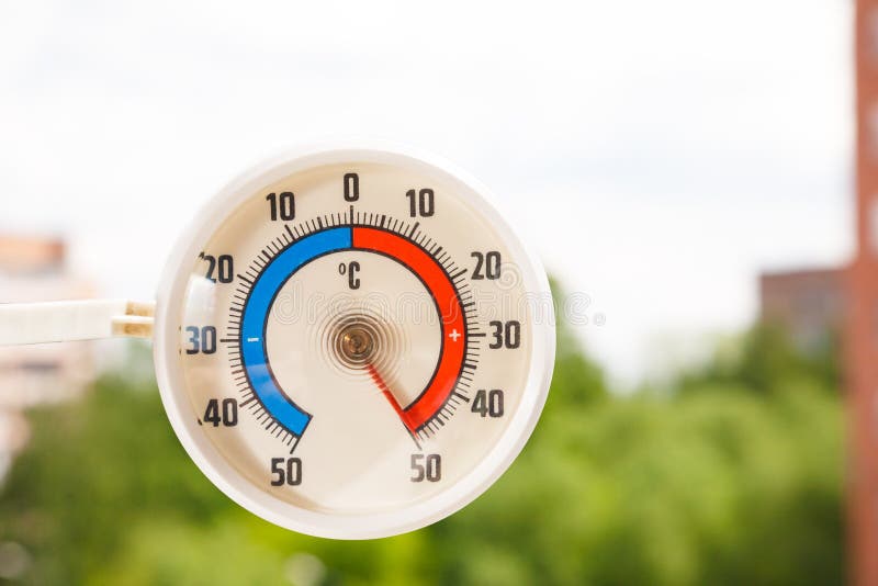 Outdoor thermometer indicating extreme high temperature Stock