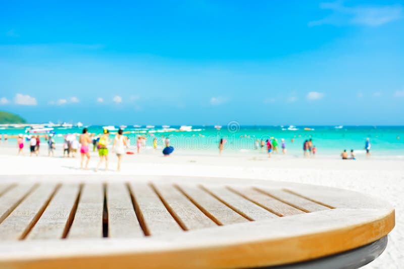 Round table top on blur beach background with people royalty free stock photo Round table top on blur beach background with people royalty free stock photo