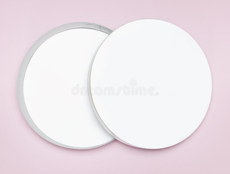 Round white cardboard blank box top view flat lay. Mock up on pink background. Packaging design, an empty box for shopping. Mockup for design royalty free stock photography Round white cardboard blank box top view flat lay. Mock up on pink background. Packaging design, an empty box for shopping. Mockup for design royalty free stock photography