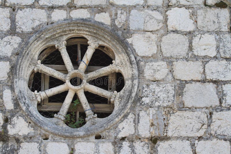 Round window in an old stone wall