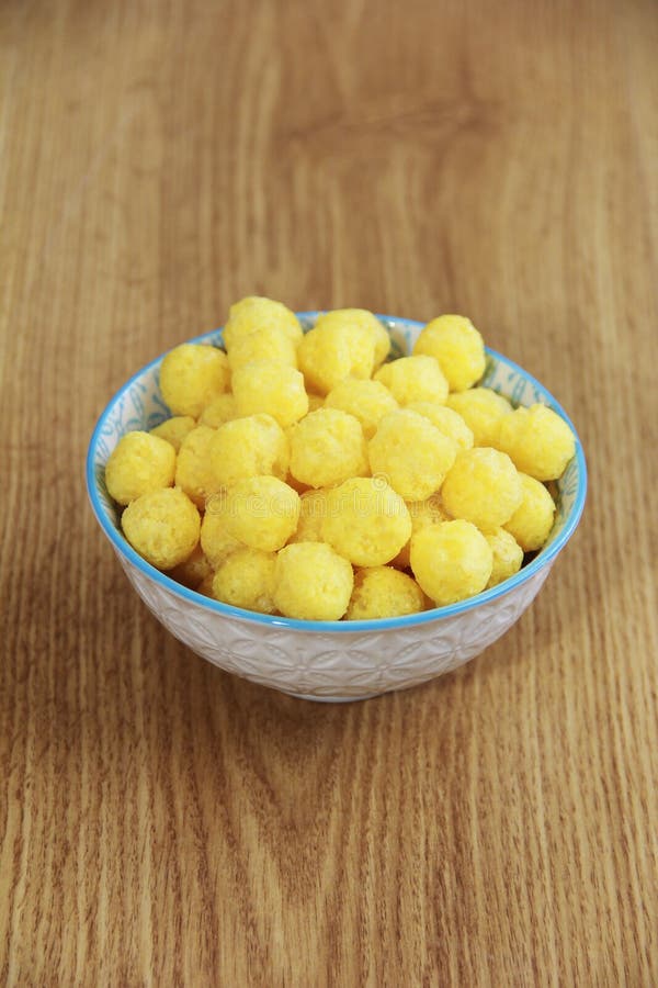 Round Yellow Natural Corn Balls for Breakfast in a Ceramic Plate Stock
