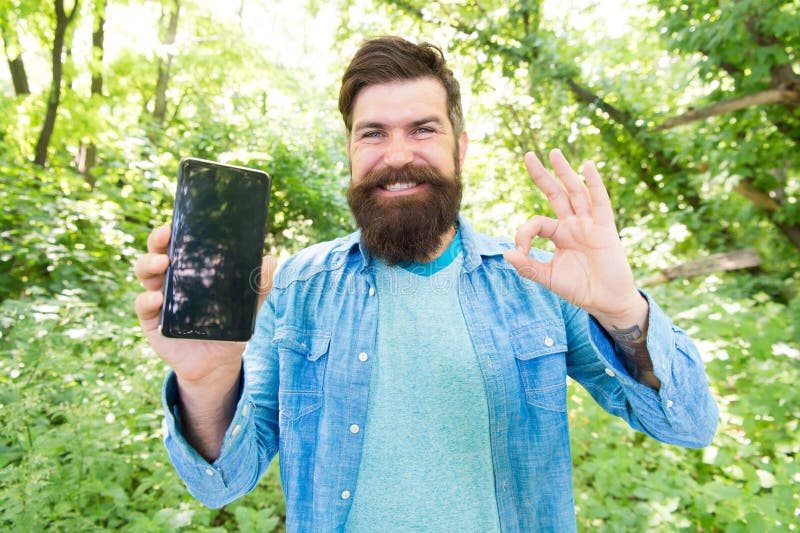 Route for exciting adventure. Best GPS and navigation apps. Man bearded wanderer walking in forest with navigation royalty free stock images