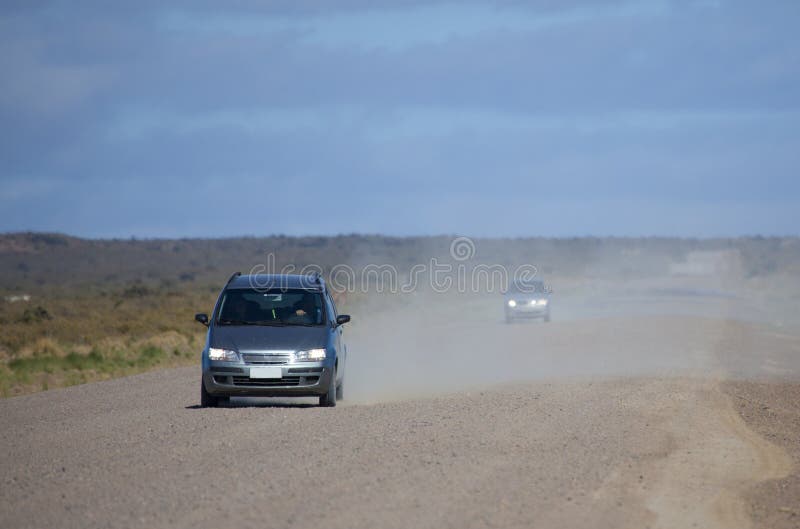 Car driving along a dusty road. Car driving along a dusty road