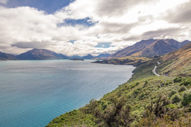 Winding close to the shoreline of Lake Wakatipu near Queenstown, New Zealand, a spectacular road leads to the small town of Glenorchy at the head of the lake through forested mountains. Winding close to the shoreline of Lake Wakatipu near Queenstown, New Zealand, a spectacular road leads to the small town of Glenorchy at the head of the lake through forested mountains