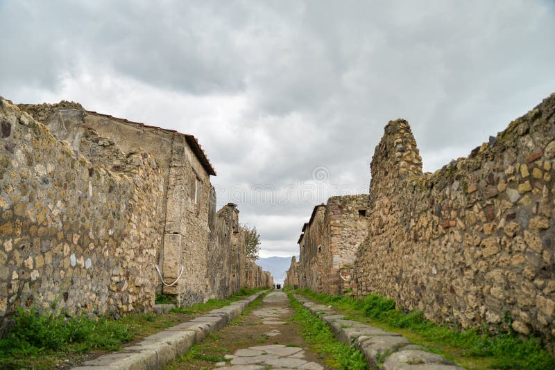 Ruins of ancient city of Pompeii, destroyed by volcano Mount Vesuvius, two millenniums ago, 79 AD. open for visitors, a popular destination for tourists in Italy. Ruins of ancient city of Pompeii, destroyed by volcano Mount Vesuvius, two millenniums ago, 79 AD. open for visitors, a popular destination for tourists in Italy