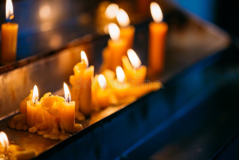 Row Candles in Church. Candle Light Flame in Worship Stock Image