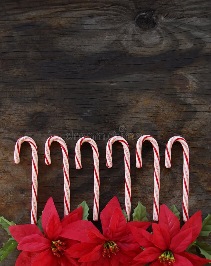 Row of Candy Canes on old, weathered wood. Row of Candy Canes on old, weathered wood.