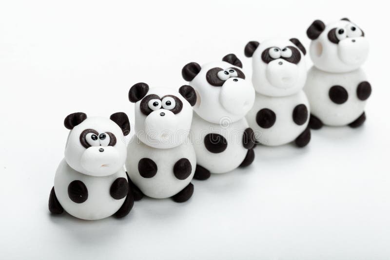 Row of panda clay toys on white background. Row of panda clay toys on white background