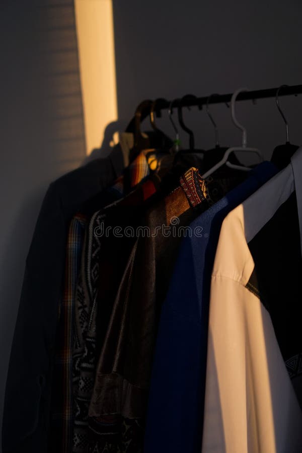 Row of Clothing Items, Including Shirts, Hung on a Rack Stock Photo ...