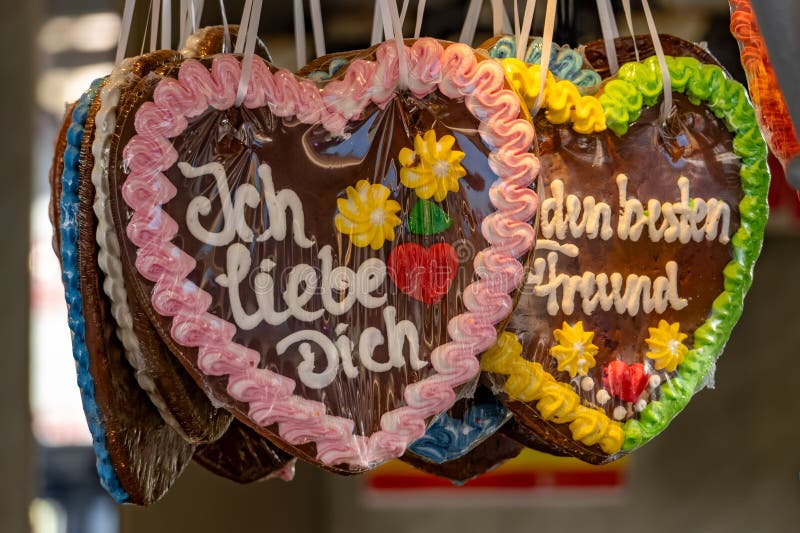 A row of colorful heart-shaped cookies with the words "Ich liebe dich doch" written on them