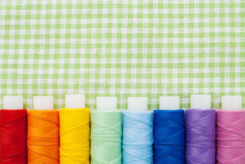 Row of colorful thread spools royalty free stock photos