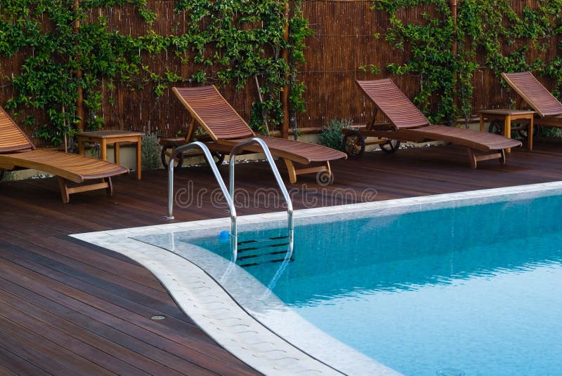 A row of empty pool chairs.