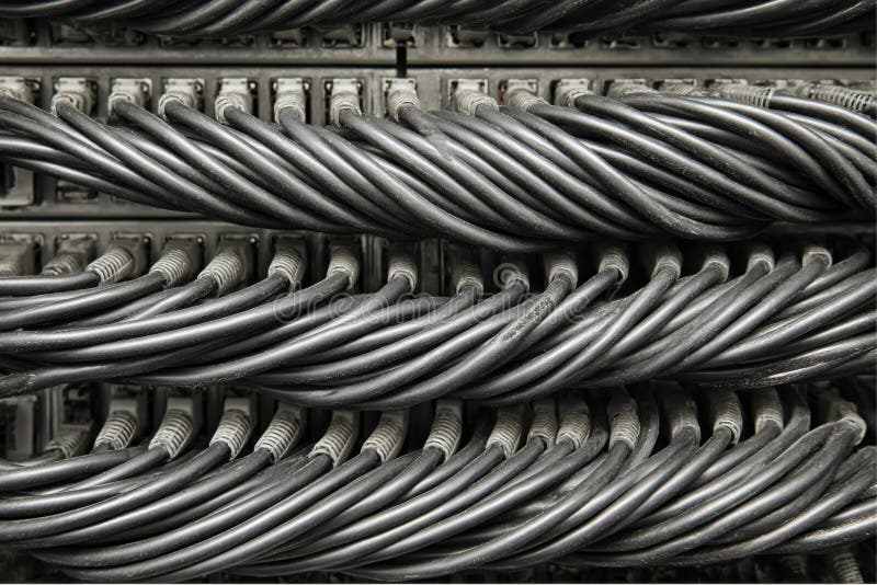 Row upon row of ethernet cables plug into a patch panel in the server room royalty free stock photos