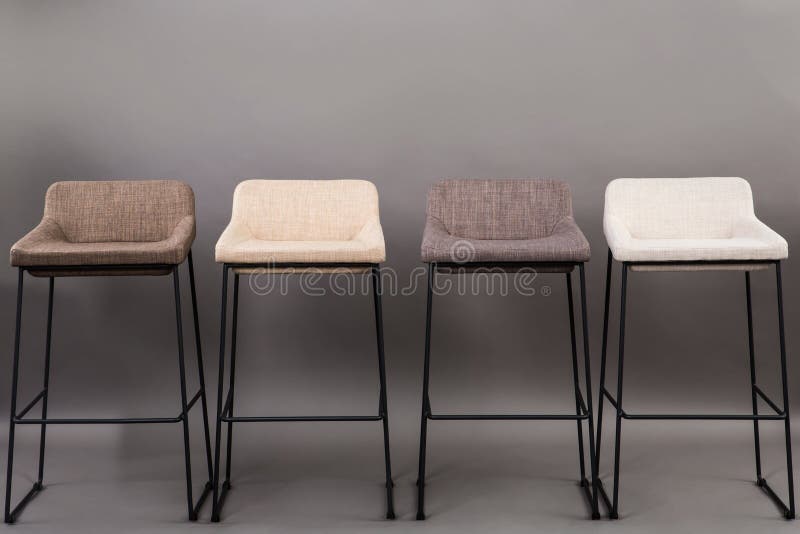 Row of four modern bar chairs isolated on gray background. Furniture series.