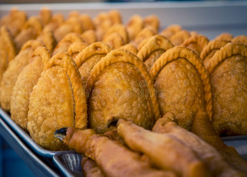 Row of freshly baked empanadas on a street corner in mexico city. Row of freshly baked empanadas on a street corner in mexico city