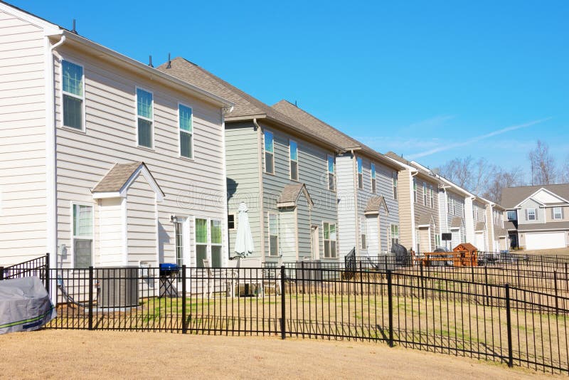 Row of generic houses from backyard view in a southeast U.S. suburb on a beautiful blue sky day