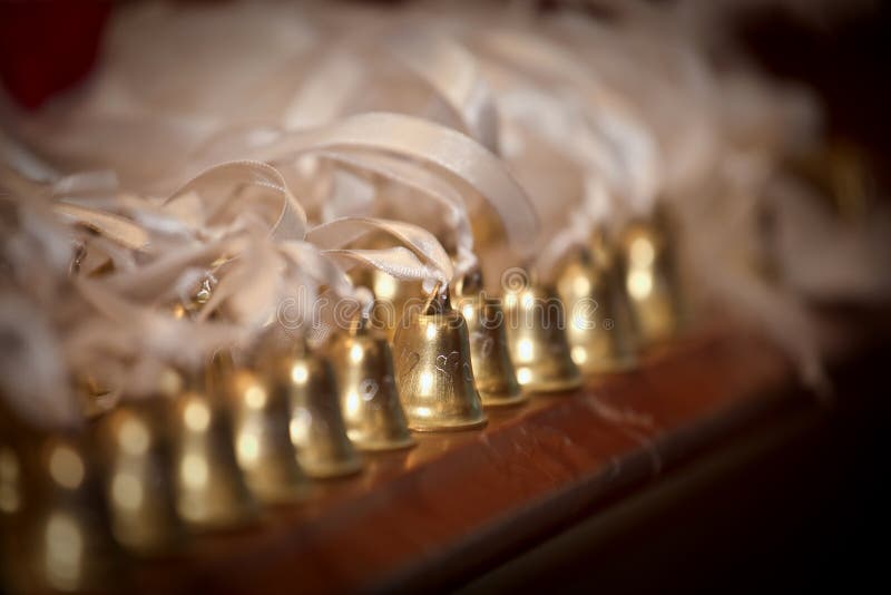 A row of golden handbells with ribbons stock photo A row of golden handbells with ribbons stock photo