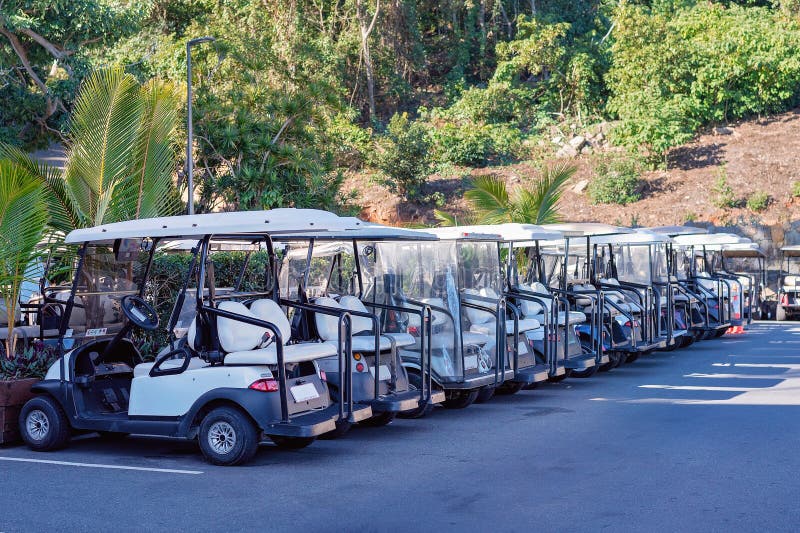 A row of golf buggies for guest use on Hamilton Island, Whitsundays, Australia. A row of golf buggies for guest use on Hamilton Island, Whitsundays, Australia