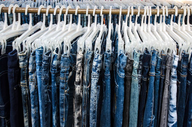 Row of Jeans and Trousers on Hangers for Sale Stock Photo - Image of ...