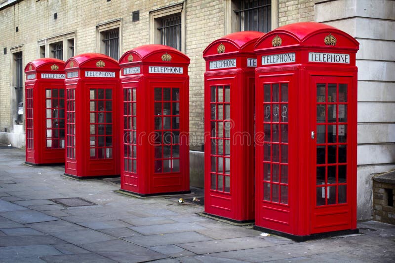 Row of old style UK red phone boxes