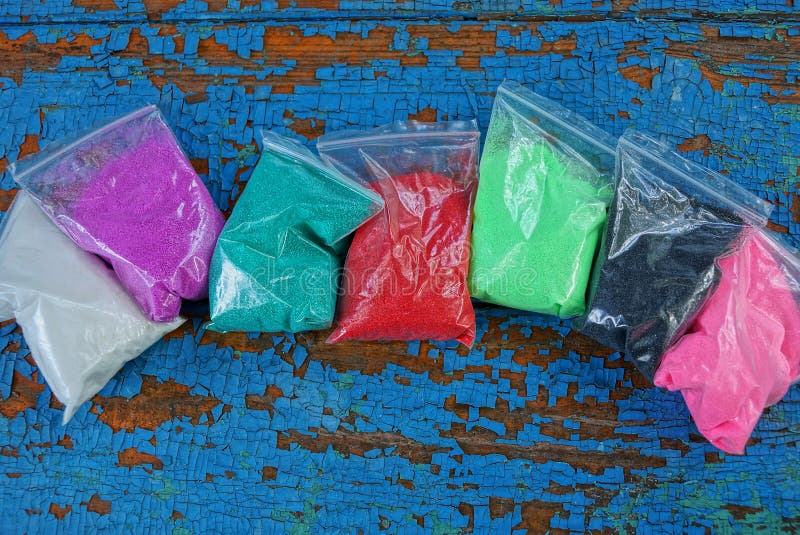 Plastic Bags with Colored Sand on a Blue Table Stock Photo Image of