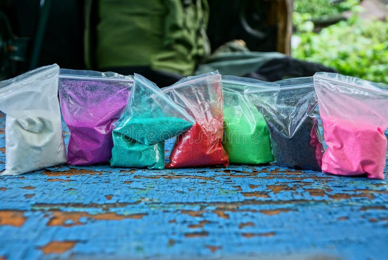 Plastic Bags Of Colored Sand On A Blue Table Stock Image Image of