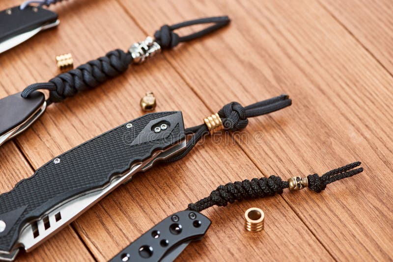 Row of Pocket Knives Decorated with Handmade Paracord