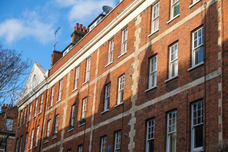 A Row of Brick Buildings with Black Doors on a Street in London Stock Image  - Image of architecture, english: 189002149