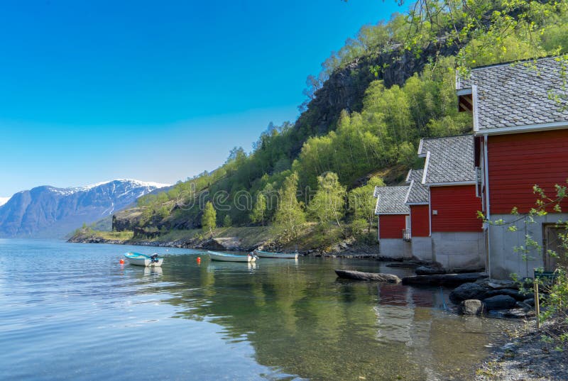 A row of red small houses with small boats at Flam village royalty free stock photography A row of red small houses with small boats at Flam village royalty free stock photography