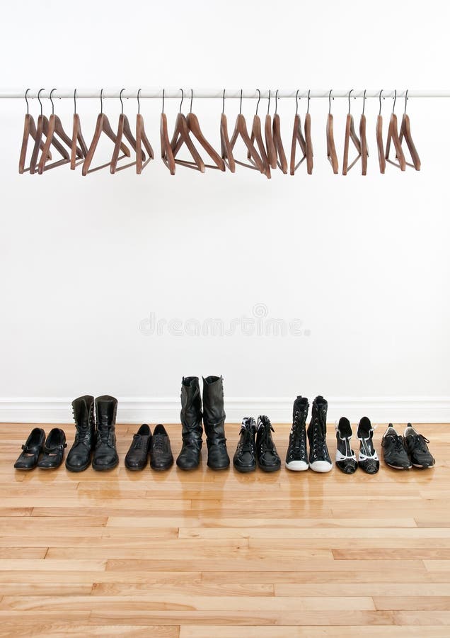 Row of shoes and empty hangers