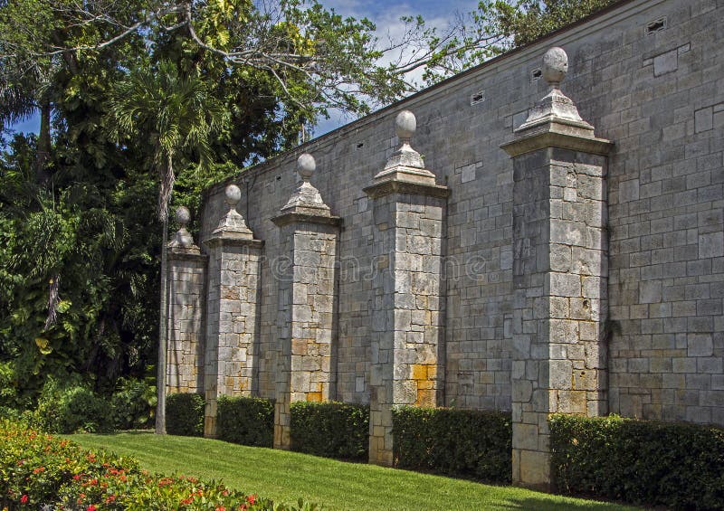 A row of pillars against a stone wall of an ancient building. Pillar column garden stock images, royalty-free photos and pictures