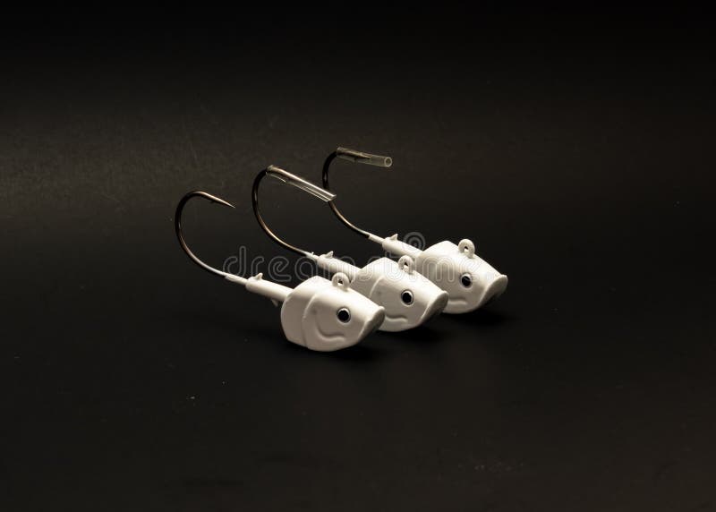 A Row of Three 2oz White Shad Jig Heads with Plastic Fishing Hook