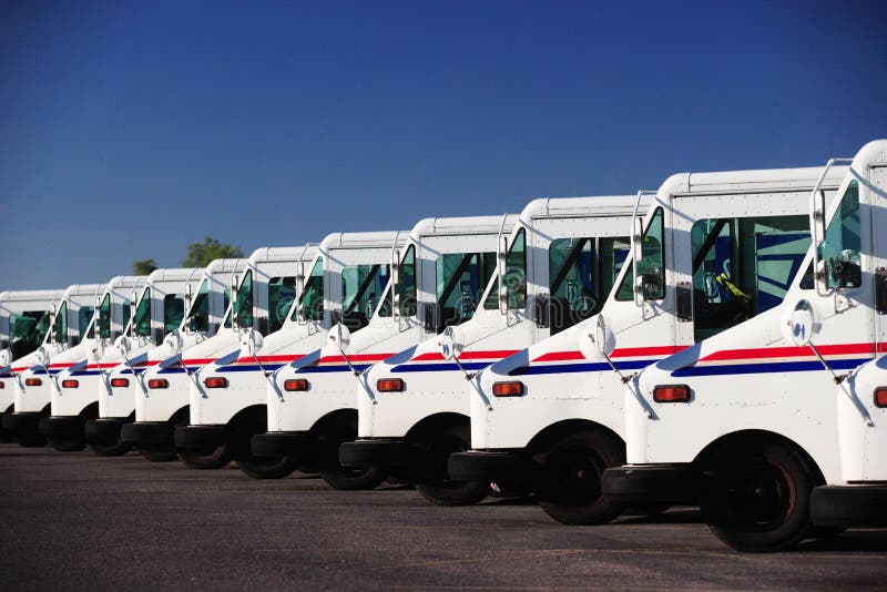US postal service trucks parked in a line.